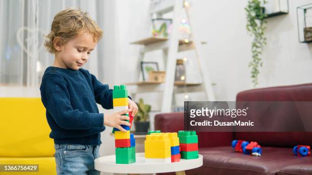 child playing with toy blocks. toys for kids. - the two towers stock pictures, royalty-free photos & images