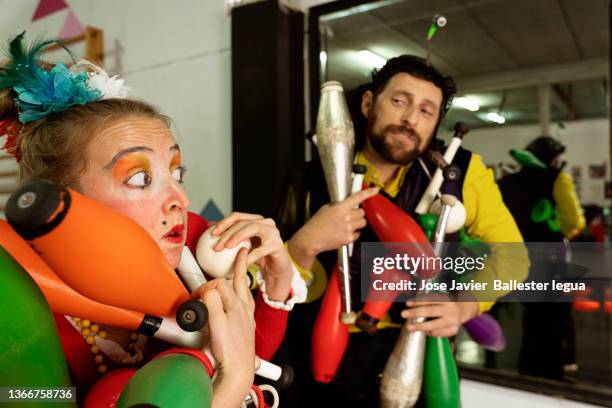 juggler maces, clowns and circus performers performing before the show during warm-up exercises.comedian - comedian on stage stock pictures, royalty-free photos & images