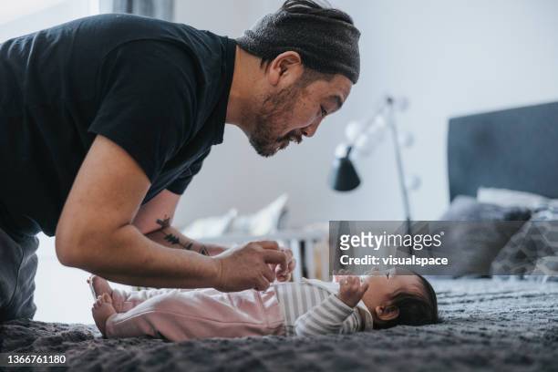 father and daughter spending time together at home - nappy change stock pictures, royalty-free photos & images