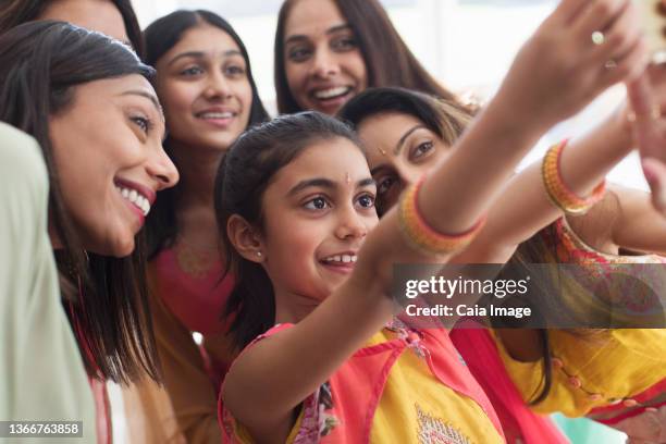 smiling indian women and girls in saris taking selfie - indian art culture and entertainment stock pictures, royalty-free photos & images