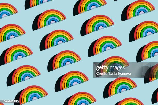 pattern of a wooden rainbow toy on blue background - free childcare stock pictures, royalty-free photos & images