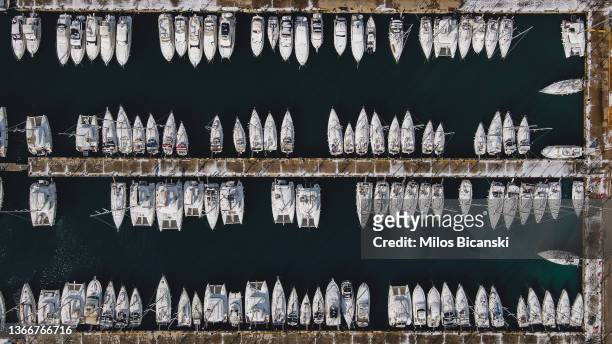 Sailing boats are seen covered with a snow on January 25, 2022 in Athens, Greece. A rare snowstorm blanketed the Greek capital in white and disrupted...