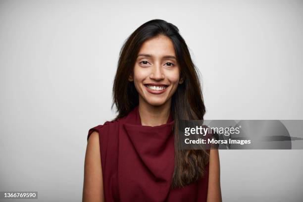 portrait of indian young businesswoman standing in front of white background - casual young woman on white background stockfoto's en -beelden