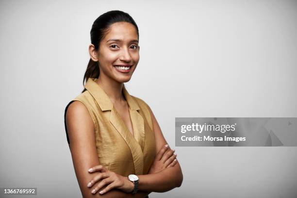 confident indian young businesswoman against white background - formelles portrait stock-fotos und bilder
