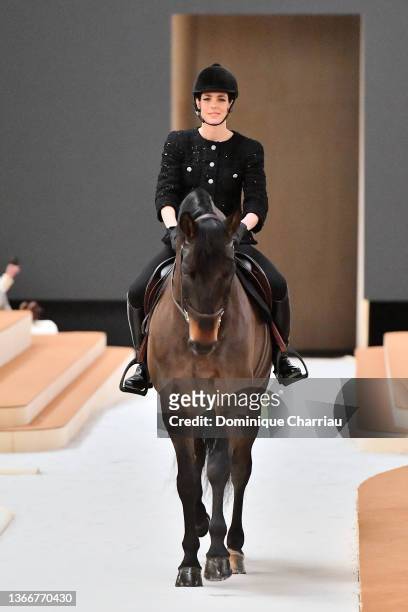 Charlotte Casiraghi rides a horse on the runway during the Chanel Haute Couture Spring/Summer 2022 show as part of Paris Fashion Week at Le Grand...