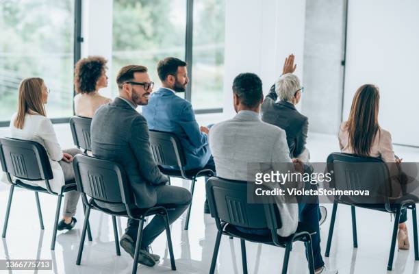 back view of business persons having a training class in a board room. - participant stock pictures, royalty-free photos & images