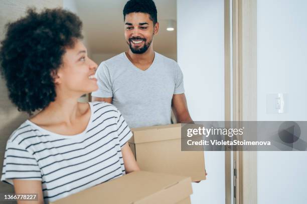 young couple moving in new home. - new boyfriend stock pictures, royalty-free photos & images