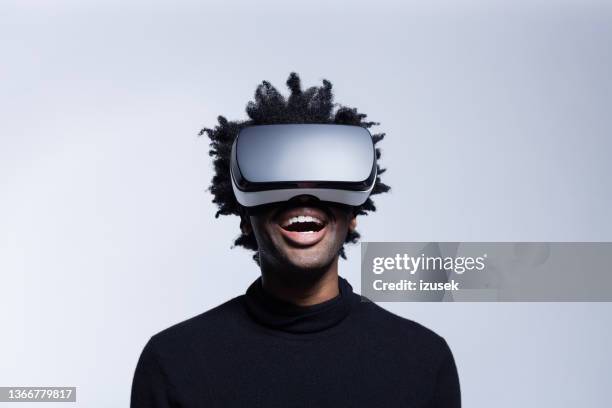 happy young man using virtual reality glasses - vr glasses imagens e fotografias de stock