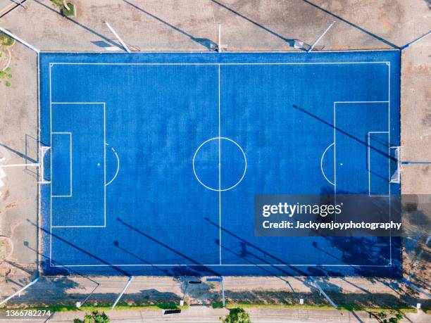 a large blue soccer field with bleachers on the side. - club soccer stock pictures, royalty-free photos & images