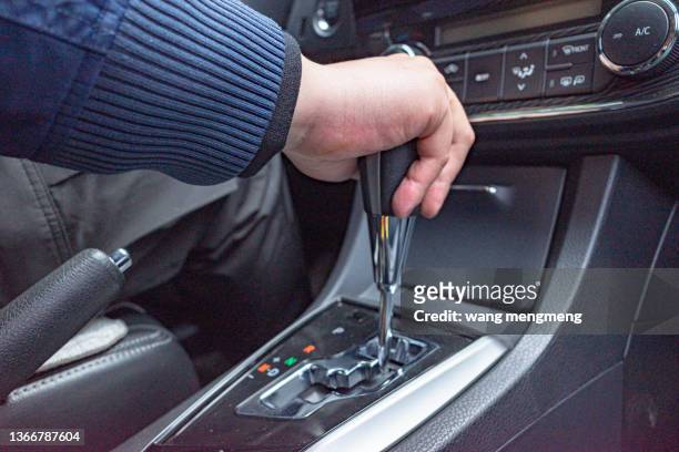 operating the gearshift lever of the automobile gearbox - accelerator stock pictures, royalty-free photos & images