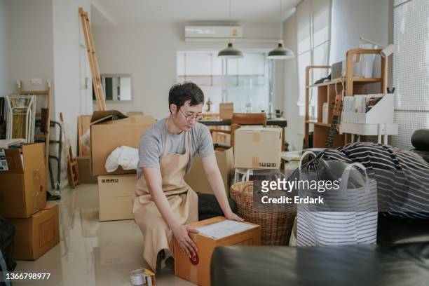 handsome man prepping donating unwanted items - unwanted present stock pictures, royalty-free photos & images