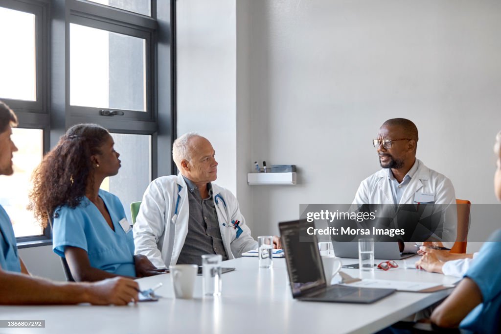 Doctor discussing with colleagues during meeting