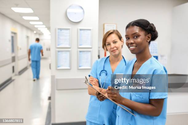 confident female nurses at hospital - female nurse stockfoto's en -beelden