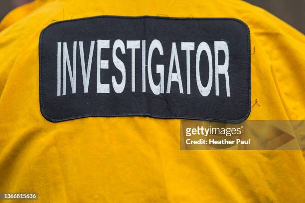 law enforcement or fire investigator identification on the back of a jacket - arson stock pictures, royalty-free photos & images