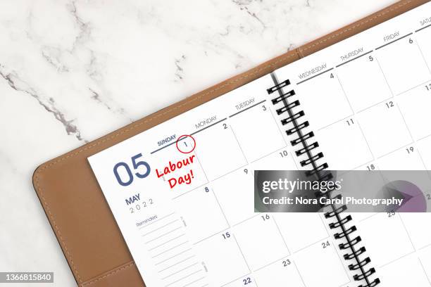 may 05 labour day date on personal organizer - may day fotografías e imágenes de stock