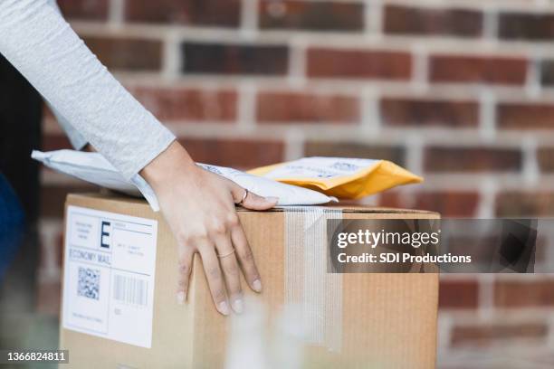 close up female picking up or delivering packages - picking up mail stock pictures, royalty-free photos & images