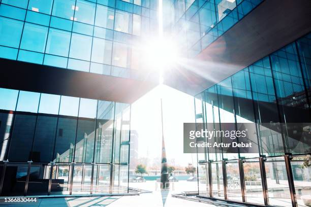 sunlight between blue modern glass architecture towers. - pointy architecture stock pictures, royalty-free photos & images