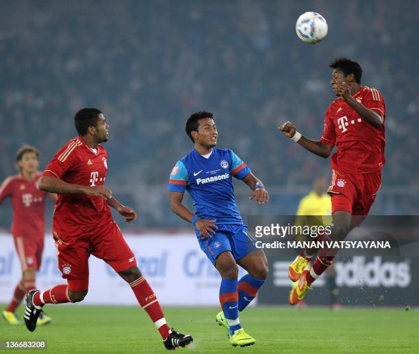 India's Jeje Lalpekhlua vies for the ball with Breno and Luiz Gustavo of Bayern Munich during a friendly football match at the Jawahar Lal Nehru...
