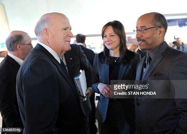 General Motors CEO Dan Akerson speaks with GM design chief Ed Welburn during the press preview day at the 2012 North American International Auto Show...
