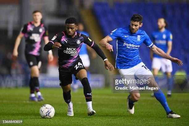 Bali Mumba of Peterborough United battles for the ball with Lukas Jutkiewicz of Birmingham City during the Sky Bet Championship match between...
