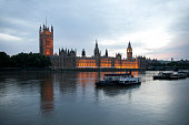 River Thames boats and Parliament at dusk