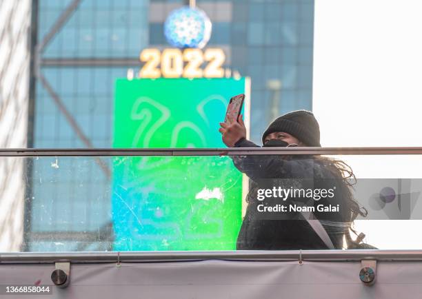 Person takes a selfie with the Times Square Ball and 2022 sign in Times Square on January 25, 2022 in New York City.