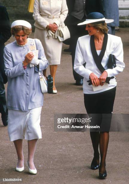 Diana, Princess of Wales , wearing a white and navy blue suit by Bruce Oldfield and a hat by Frederick Fox, attends Royal Ascot on June 18, 1985 in...