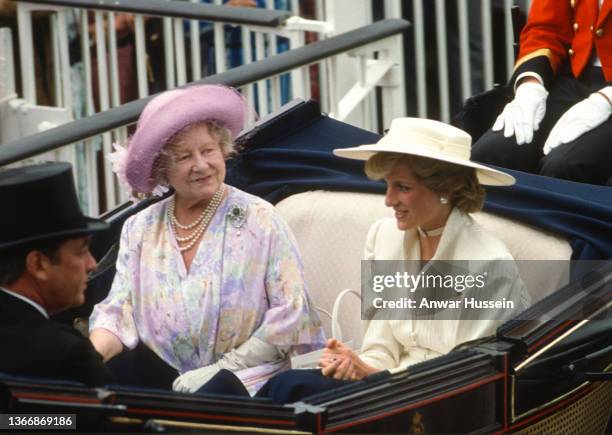 Diana, Princess of Wales, wearing a cream peplum suit designed by Victor Edelstein and a matching, straw wide-brimmed boater hat with pleated...