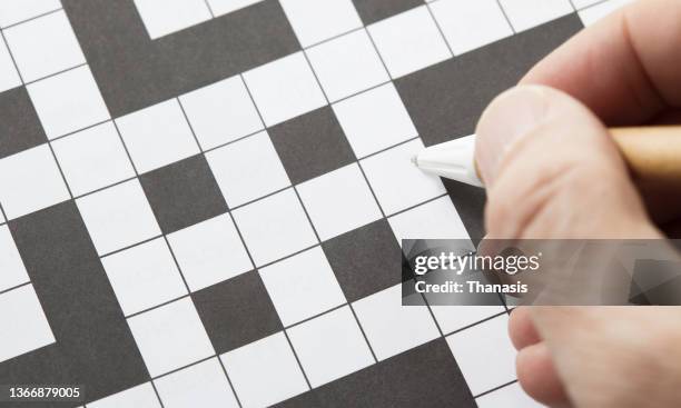 close-up on a empty crossword puzzle - crosswords stock-fotos und bilder