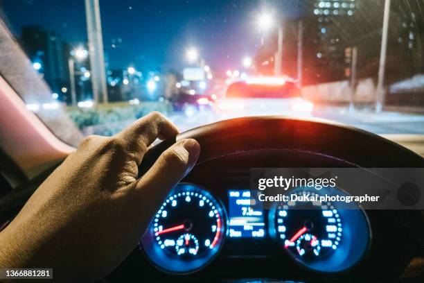 man driving at night in the crossroads - autobahn stock pictures, royalty-free photos & images