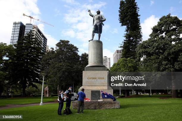 Police speak to a man who had placed his own commemoration on a Captain Cook statue in Hyde Park on January 26, 2022 in Sydney, Australia. Australia...