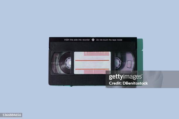 black vhs videotape with hard shadow on blue background. concept of video, movies, retro, vintage, obsolete, magnetic and cinema system. - old film stock pictures, royalty-free photos & images