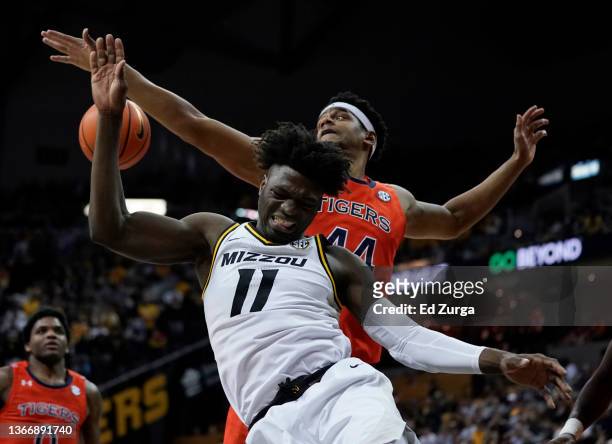 Yaya Keita of the Missouri Tigers is fouled by Dylan Cardwell of the Auburn Tigers as he shoots in the second half at Mizzou Arena on January 25,...
