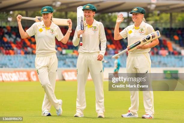 Australian women's cricket team members Ellyse Perry and Meg Lanning look on as Alyssa Healy waves during a Women's Ashes series media opportunity at...