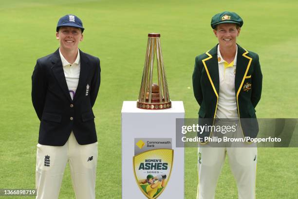 Heather Knight of England and Meg Lanning of Australia pose with the series trophy during Women's Ashes series training sessions at Manuka Oval on...