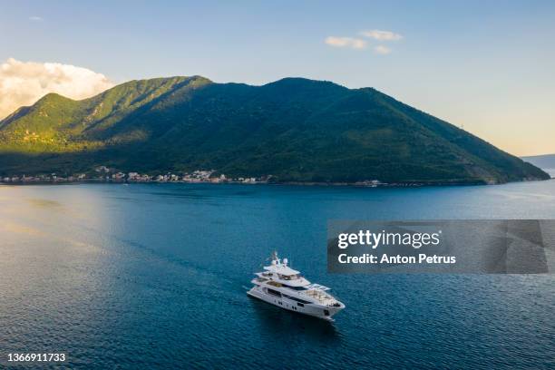 kluxury superyacht in  kotor bay at sunset. beautiful mountain landscape, montenegro. - yacht top view stock pictures, royalty-free photos & images