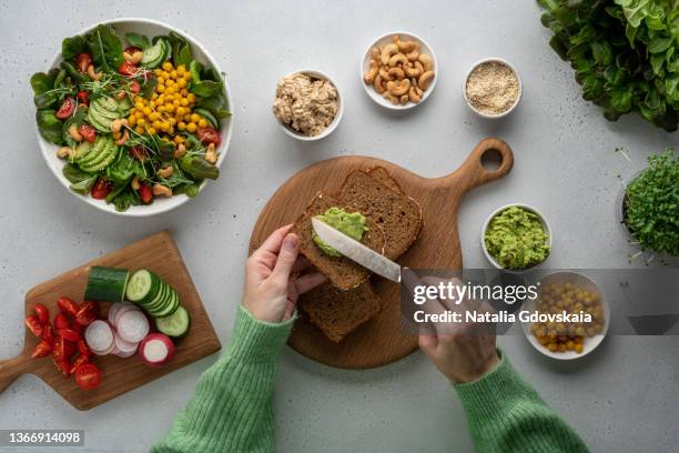 faceless woman making toast for lunch with healthy vegetable salad. plant-based food concept - fibra fotografías e imágenes de stock