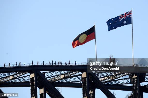 The Aboriginal flag flies alongside the Australian flag on top of the Harbour Bridge as seen from the Opera House during the Australia Day Live...