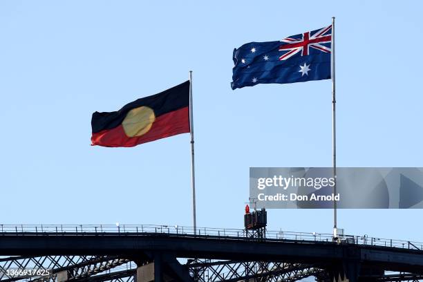 The Aboriginal flag flies alongside the Australian flag on top of the Harbour Bridge during the Australia Day Live concert at Sydney Opera House on...