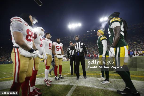 Captains of the San Francisco 49ers and the Green Bay Packers during the coin toss before the NFC Divisional Playoff game at Lambeau Field on January...