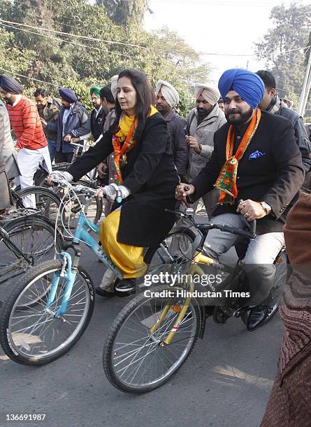 Lok Sabha MP from Amritsar and former International cricketer Navjot Singh Sidhu and his wife Navjot Kaur Sidhu riding bicycles to file her...