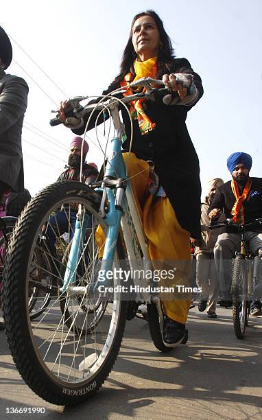 Lok Sabha MP from Amritsar and former International cricketer Navjot Singh Sidhu and his wife Navjot Kaur Sidhu riding bicycles to file her...