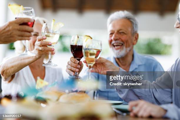 happy mature friends toasting with cocktails. - wijn drinken stockfoto's en -beelden