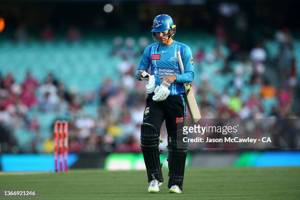 Alex Carey of the Strikers walks off the field after been dismissed by Steve O'Keefe of the Sixers during the Men's Big Bash League match between the...