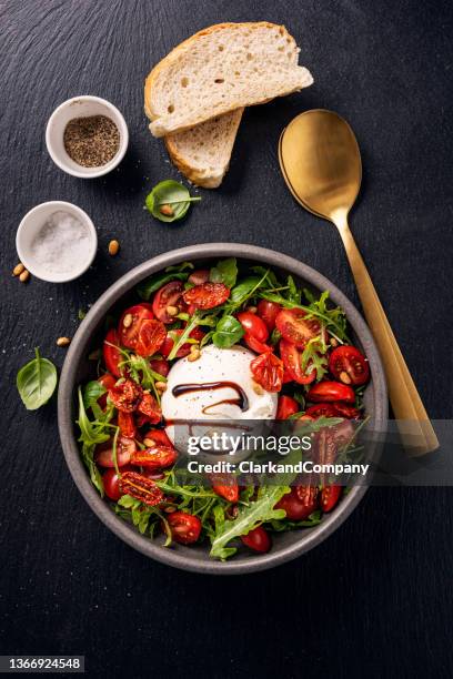 burrata with tomatoes, arugula and pine nuts. - olive oil bowl stock pictures, royalty-free photos & images