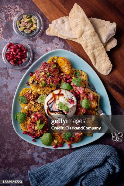 burrata salad with mandarin oranges and pomegranate. - burrata stock pictures, royalty-free photos & images