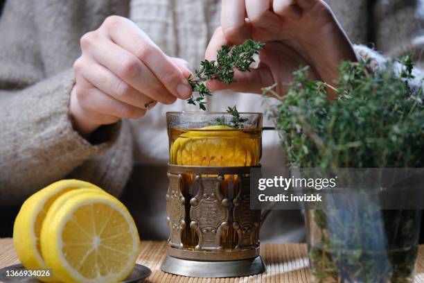 hot tea with lemon, thyme and honey - herb stockfoto's en -beelden