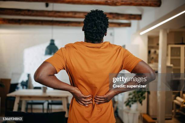 young black man having pain - inflammation stock pictures, royalty-free photos & images