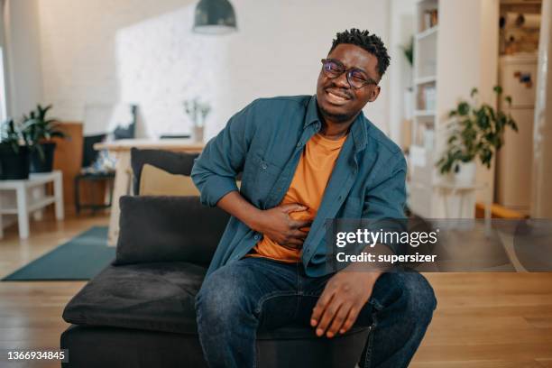 young black man having pain - human abdomen bildbanksfoton och bilder