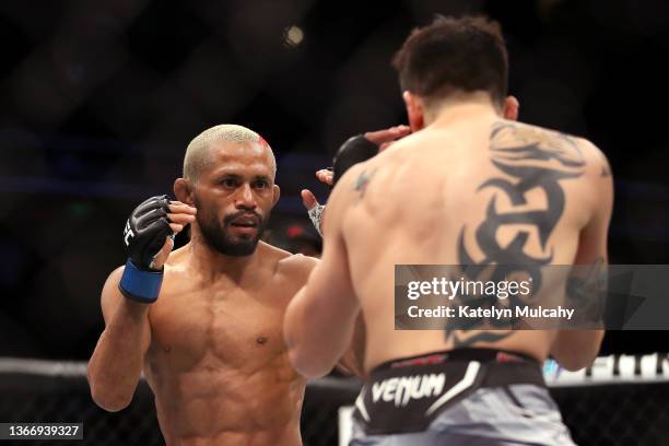 Deiveson Figueiredo of Brazil fights against Brandon Moreno of Mexico in their flyweight title fight during the UFC 270 event at Honda Center on...